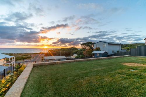 a view of the sunset from the backyard of a house at Ocean View Retreat - Best View in town in Guilderton