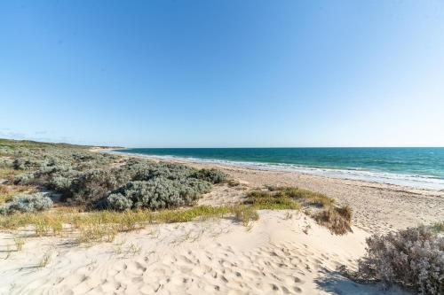 a sandy beach with the ocean in the background at Ocean View Retreat - Best View in town in Guilderton