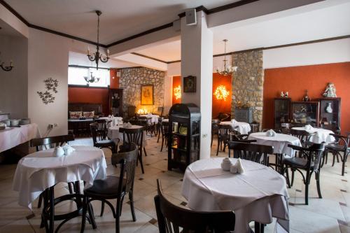 a restaurant with tables and chairs with white table cloth at Atrion Highland Hotel in Elatochori