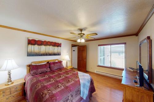 a bedroom with a bed and a ceiling fan at Royal Vista II Pool-Spa Ski-in out Gym, Sauna, Laundry, BBQ in Brian Head