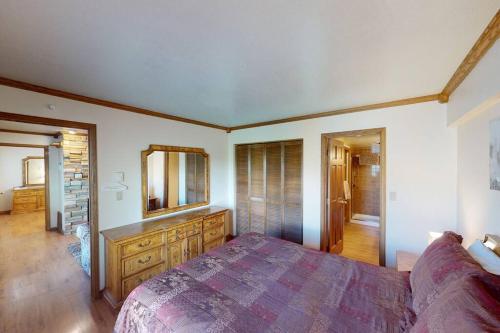 a bedroom with a bed and a dresser and a mirror at Royal Vista II Pool-Spa Ski-in out Gym, Sauna, Laundry, BBQ in Brian Head