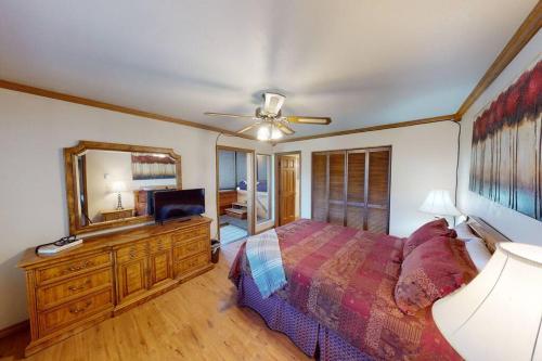 a bedroom with a bed and a dresser with a mirror at Royal Vista II Pool-Spa Ski-in out Gym, Sauna, Laundry, BBQ in Brian Head