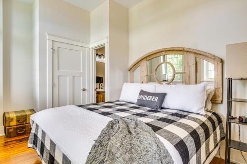 a bedroom with a large bed with a checkered blanket at West Lafayette Home about 3 Mi to Purdue Campus! in West Lafayette