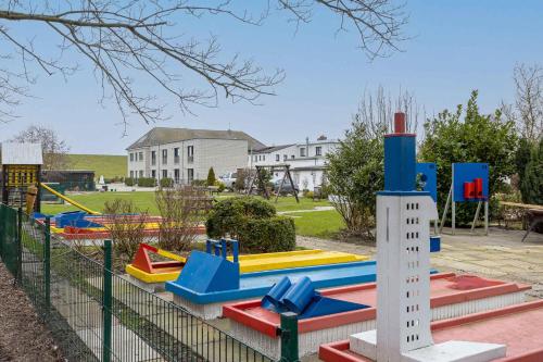 a playground with colorful play equipment in a park at Apartments in Butjadingen - Oldenburger Land 40667 in Butjadingen