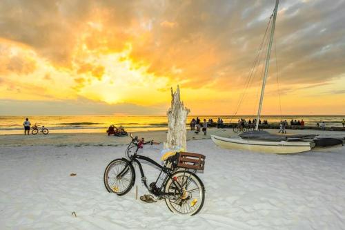 a bike parked on a beach with a boat at New Listing! Pool Jacuzzi, 3-min to Beach Bars & Entertainment! in Siesta Key