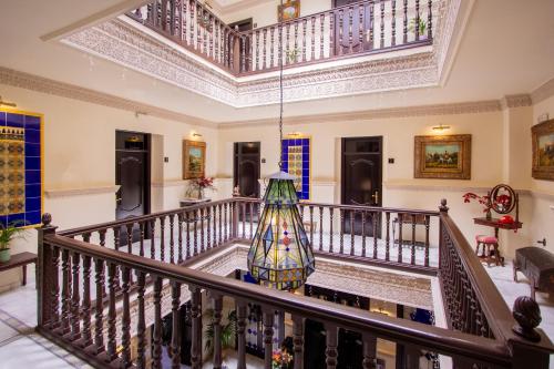 a room with a staircase with a colorful glass vase at Hotel Palacio de Hemingway in Ronda