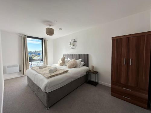 a bedroom with a large bed and a large window at Luxury central York Apartment in York