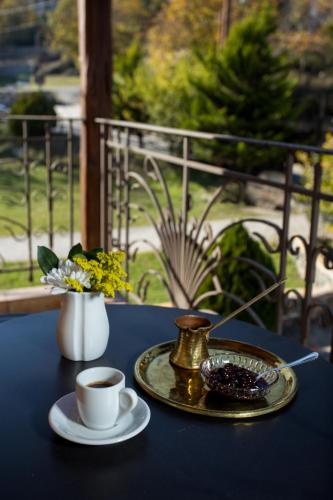 a blue table with a cup of coffee and a plate at Atrion Highland Hotel in Elatochori