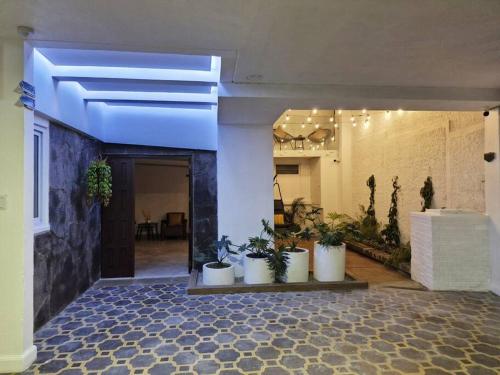 a hallway with potted plants in a building at Moderno y Confortable Apto 4 Familiar Primer Nivel in El Rodeo