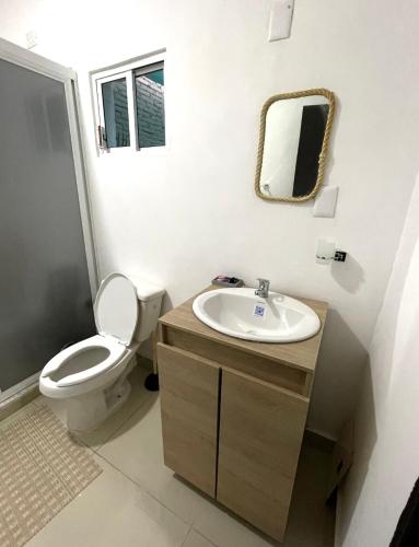 a bathroom with a toilet and a sink at Torre Loshea in Culiacán
