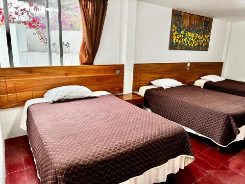 Postel nebo postele na pokoji v ubytování Hostal Muyuyo
