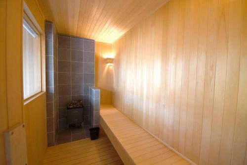 a hallway of a bathroom with a toilet and a light at Chalet Tacito Niseko Luxury Stay in Niseko