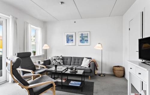 a living room with a couch and a table at Two-Bedroom Apartment In Rudkobing in Rudkøbing