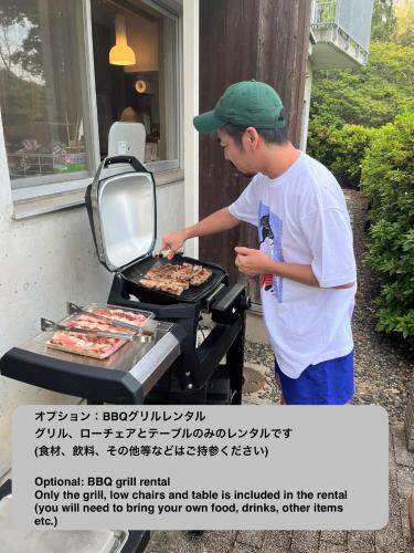 a man is cooking food on a grill at Shiki&Kura in Kurashiki