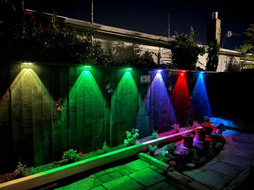 a fence with colorful lights on a fence at Parkview Holiday Homes "Opposite of Famous Kuirau Park" in Rotorua