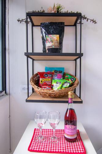 a table with two wine glasses and a basket of food at Casa Viva Alojamiento Rural in Jardin