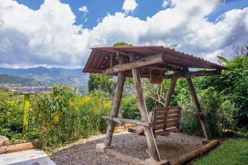 a small wooden structure with a roof on top at Casa Viva Alojamiento Rural in Jardin