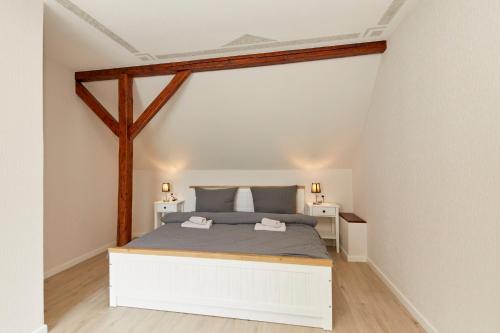 a bedroom with a white bed in a attic at Haus am Hafen in Bernkastel-Kues
