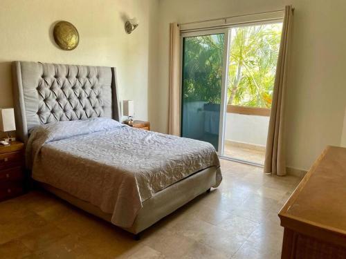 a bedroom with a large bed and a large window at Cozy family house with pool in Puerto Vallarta