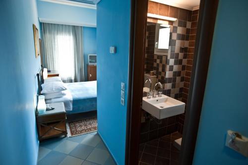 a hotel room with a bed and a sink at Akti in Nafpaktos