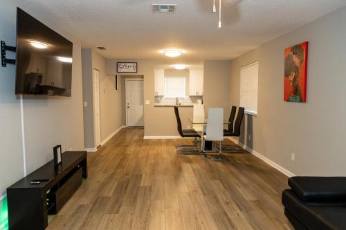 an empty living room with a table and chairs at Cozy and Modern Vacation Home in Hallandale Beach