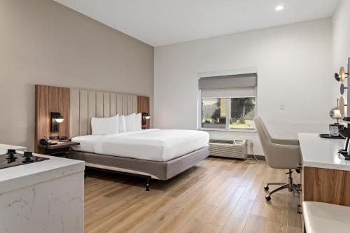a hotel room with a bed and a desk at Hawthorn Extended Stay by Wyndham Port Arthur in Port Arthur