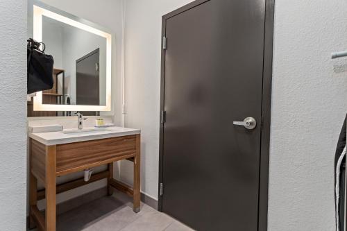 a bathroom with a sink and a mirror at Hawthorn Extended Stay by Wyndham Port Arthur in Port Arthur