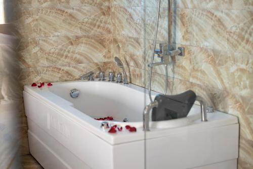 a bath tub with a faucet in a bathroom at HAAP Transit Hotel in Noi Bai