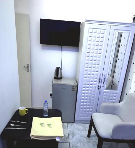 a living room with a couch and a table and a tv at PHENOMENAL SEA VIEW in Abu Dhabi
