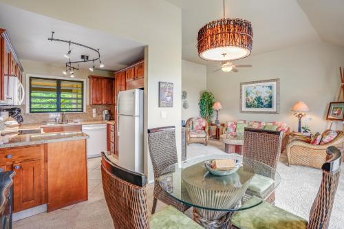 a kitchen and dining room with a glass table and chairs at Ocean View at Kaha Lani 310 in Lihue