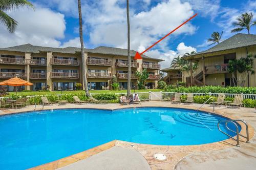a swimming pool in front of a resort at Ocean View at Kaha Lani 310 in Lihue