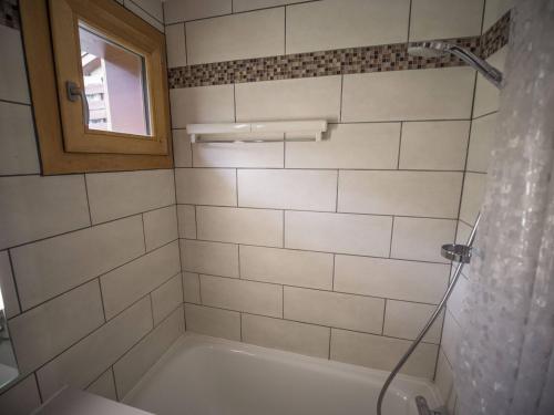 La salle de bains est pourvue d'une baignoire avec rideau de douche. dans l'établissement Valmorel, 2 pièces + mezzanine, 6 pers, simple, animaux, skieurs - FR-1-356-479, à Valmorel