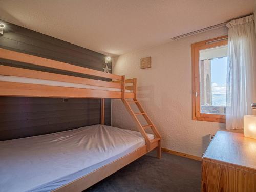 une chambre avec deux lits superposés et une fenêtre dans l'établissement Valmorel: Appt 32m², skis aux pieds, balcon, casier à skis - FR-1-356-486, à Valmorel