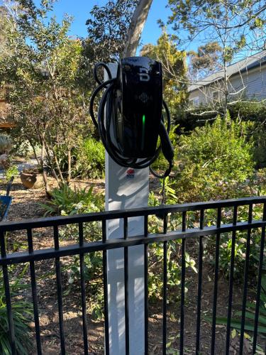 a backpack on a pole next to a fence at Blackheath Suite (2 b/rooms) Family/Pet Friendly in Blackheath