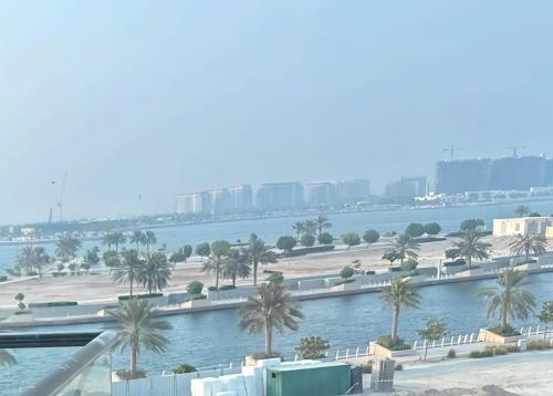 a view of a body of water with palm trees at PHENOMENAL SEA VIEW in Abu Dhabi