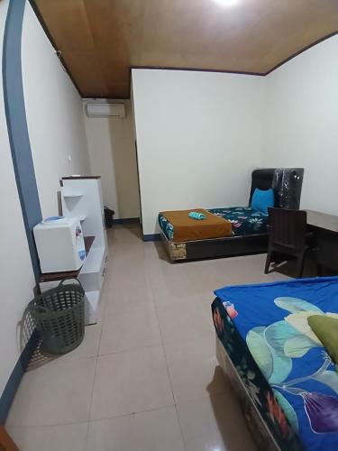 Ένα ή περισσότερα κρεβάτια σε δωμάτιο στο Dannyjuljolhomestay