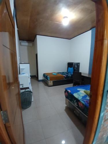 Ένα ή περισσότερα κρεβάτια σε δωμάτιο στο Dannyjuljolhomestay