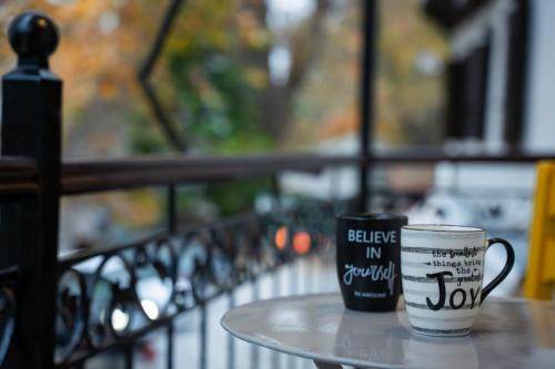 two coffee cups sitting on top of a table at Toma's House in Makrinítsa