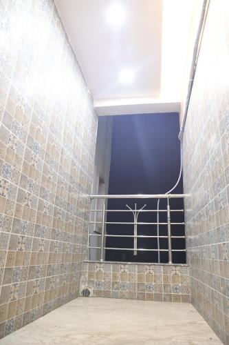 a room with a staircase with tiled walls at Hotel Radiant in Jamshedpur