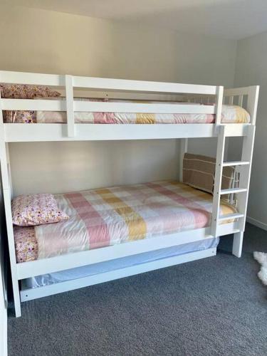 a bedroom with two bunk beds in a room at Jacks Point Getaway in Frankton Wharf