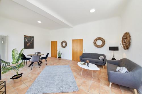a living room with two couches and a table at Ferienwohnungen am Gestade Wohnung 2 in Bernkastel-Kues