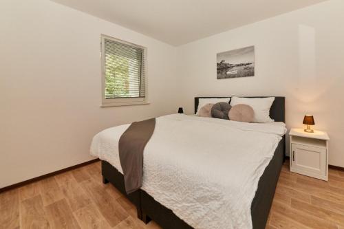 a bedroom with a large bed and a window at Alte Brauerei Wohnung 8 in Bernkastel-Kues