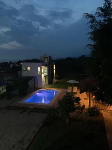 a backyard with a swimming pool at night at Casa Carolina Loft Aryaz in Tepoztlán