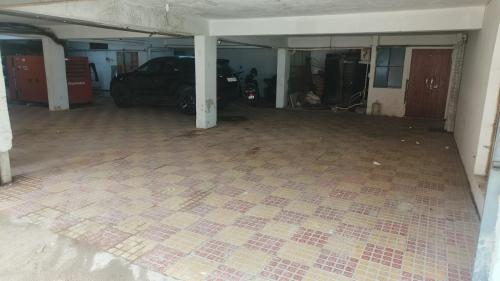 an empty garage with a car parked in it at Treebo Destination Inn in Hyderabad