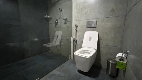 a bathroom with a toilet and a shower stall at ART Marari Beach house in Mararikulam
