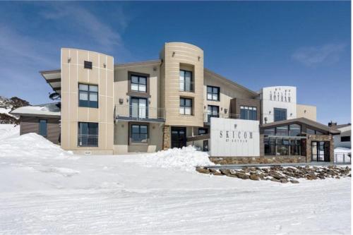 a building with snow in front of it at Chalet Hotham 18 in Mount Hotham
