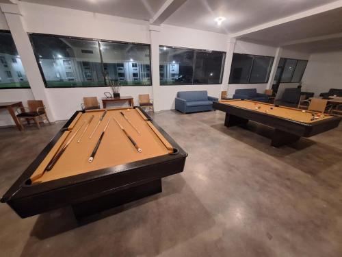a large room with two pool tables and couches at The Hotel Orange in Orange