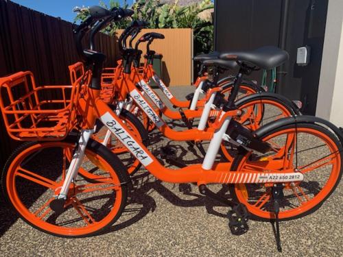 two orange bikes are parked next to each other at Baligara Absolute Oceanfront Guest Suite in Bargara