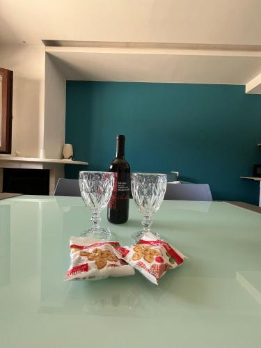 a bottle of wine and two glasses on a table at Villa Paternelli in Bisceglie