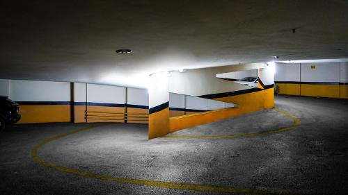 an empty parking garage with yellow and blue walls at The Grand Mira Business Hotel in Istanbul